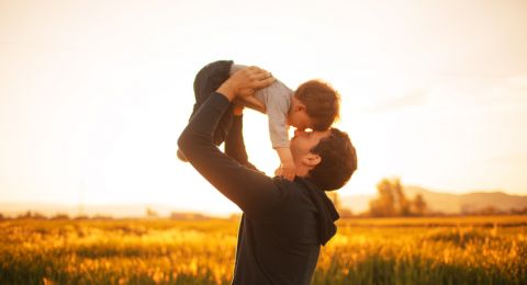 Father lifting child outdoors