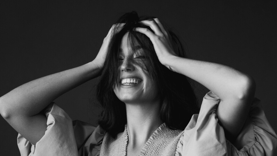 Woman laughing in dark room