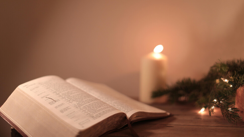 Bible with glowing candle