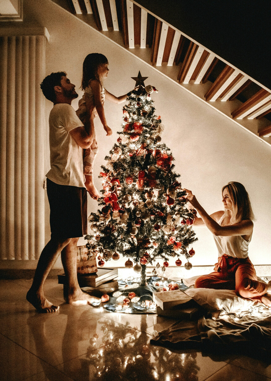 Family decorates Christmas tree together