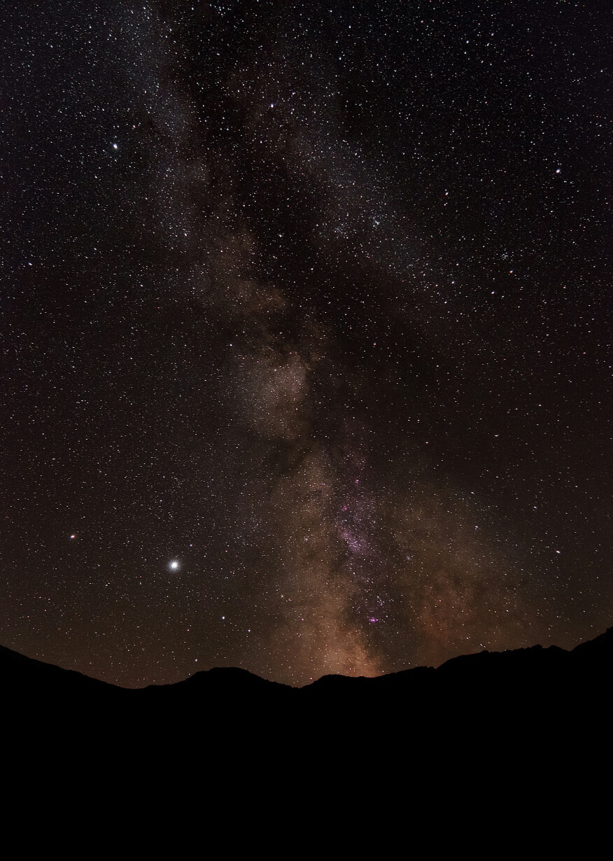 Starlit night over dark hillside