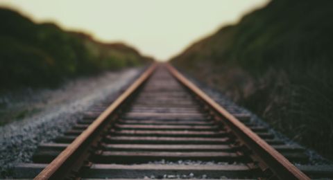 Blurred train tracks vanishing into distance