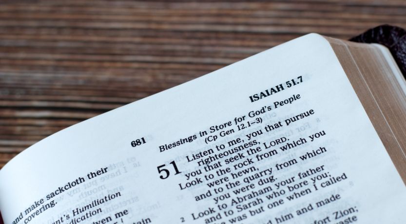 Bible open on wood desk