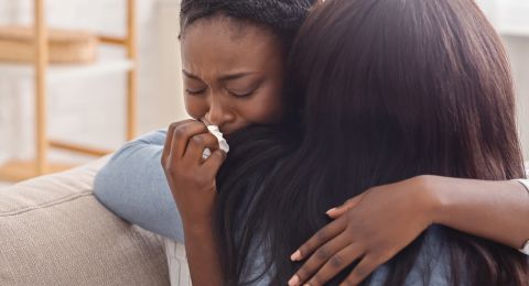 Woman comforting grieving person