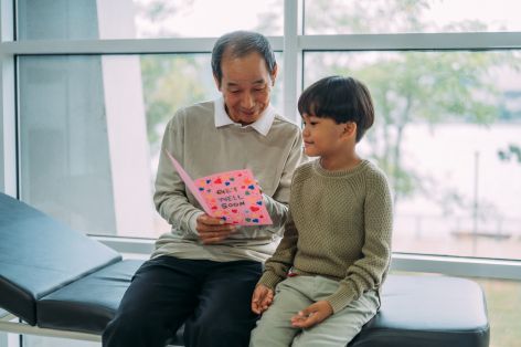 Man and boy reading get-well card