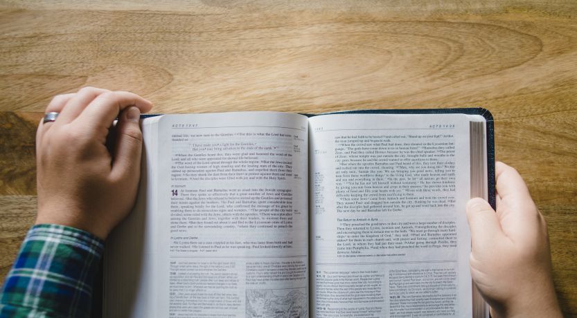 Open Bible held in hands