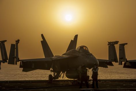 Military jet on aircraft carrier