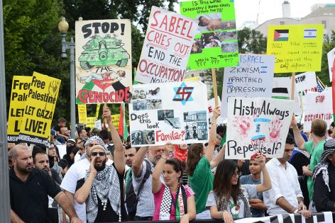 Protesters with anti-Israel signs