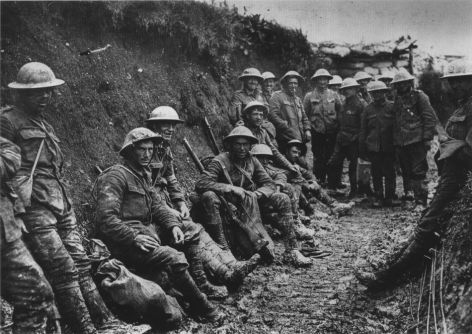 WWI soldiers crouched in trench