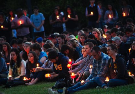 Mourners holding candles at vigil