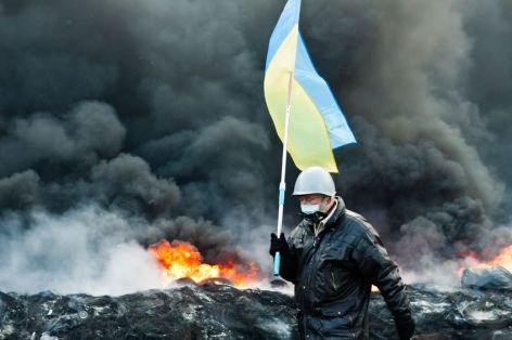 Protester in burning Ukrainian street