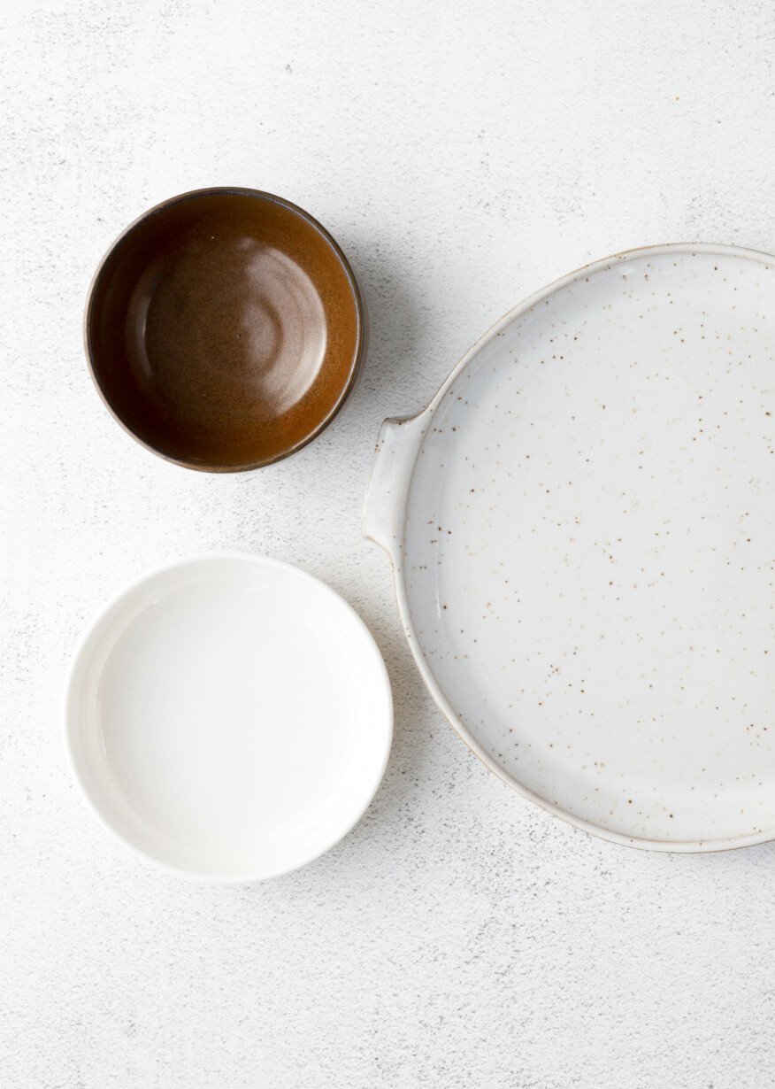 Three dishes on white surface