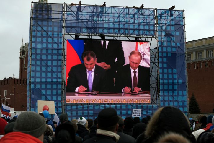 Two men signing document in Crimea