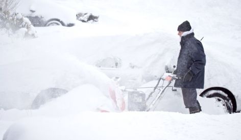 Man shoveling snow in winter