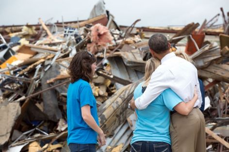 Family embraces amid tornado destruction