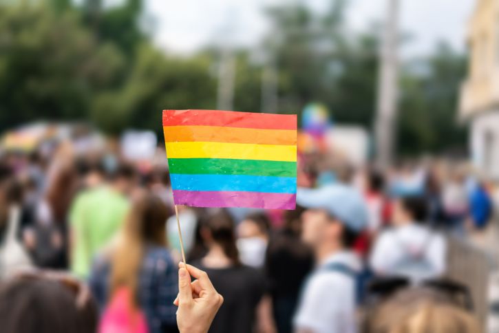 Person holding rainbow pride flag