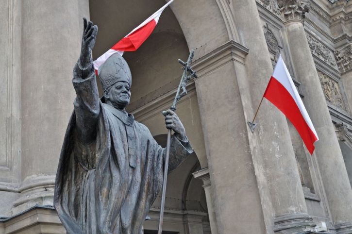 Bishop statue with raised flag