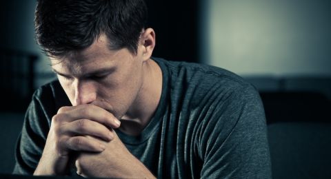 Man praying with bowed head