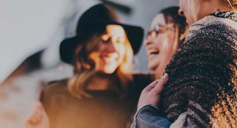 Three women laughing together