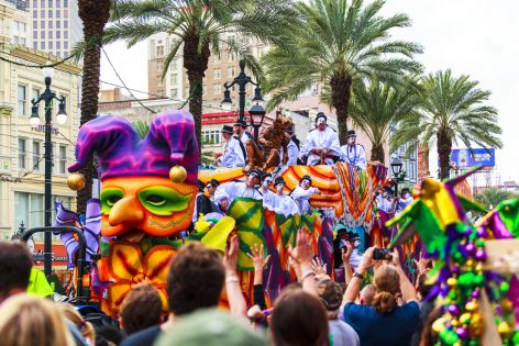 Colorful Mardi Gras parade float and crowd