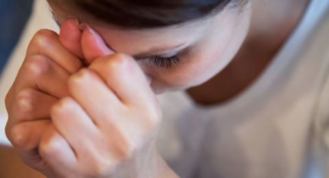 Woman praying with bowed head