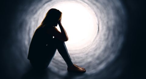 Worried woman sitting in tunnel