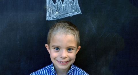 Boy smiling at chalkboard