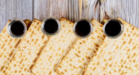 Matzah bread beside Passover wine glass