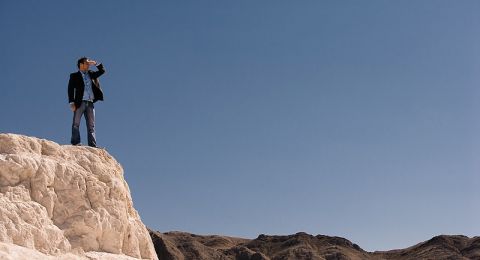 Man stands on coastal rocks