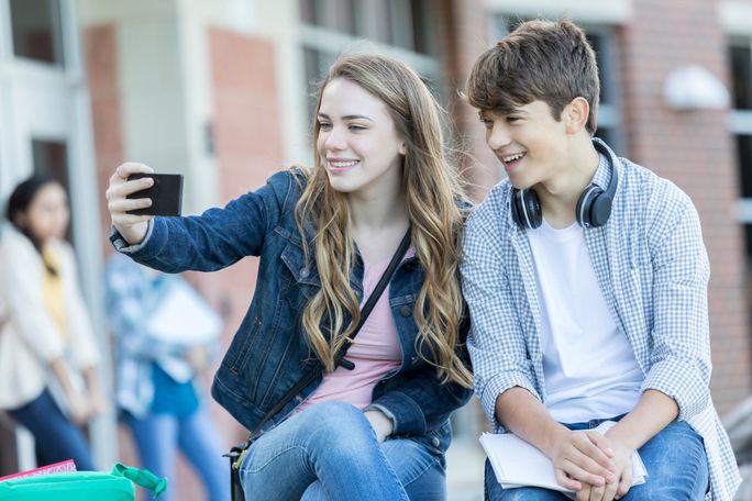 Teens taking selfie while dating