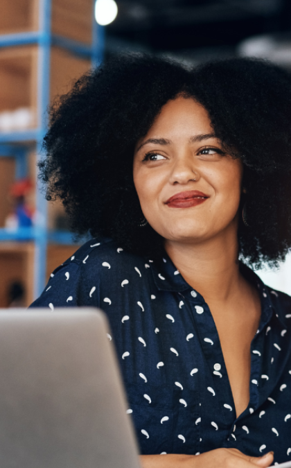 Smiling woman working on laptop