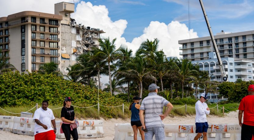 People by Surfside condo collapse debris