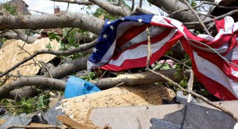 Tattered US flag amid destruction