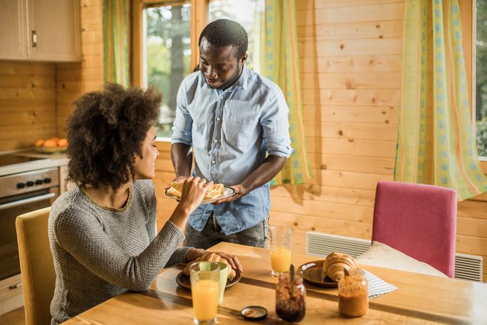 Man serves woman slice of pie