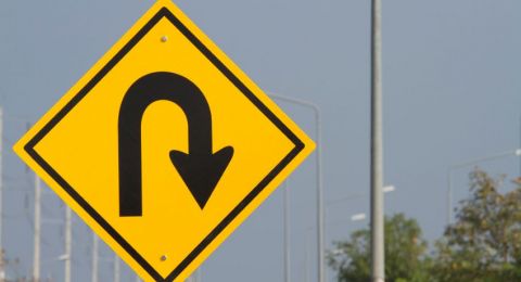 White U-turn arrow on asphalt