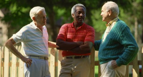 Three men chatting near church