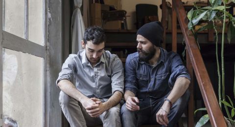 Two men discussing at table