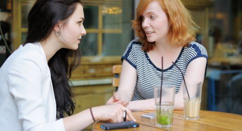 Two women discussing conflict peacefully