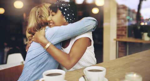 Two women reconciling in cafe