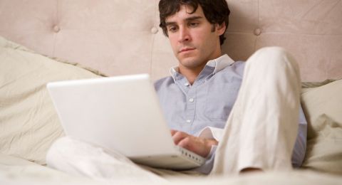 Man sitting at computer feeling ashamed