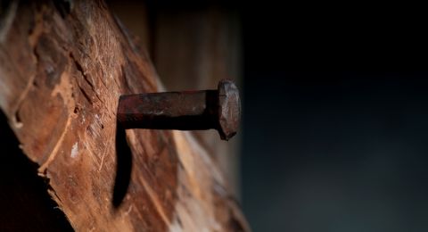 Rusty nail in wood cross