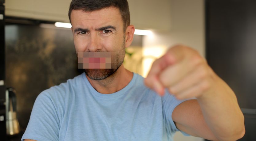 Man pointing accusingly at viewer